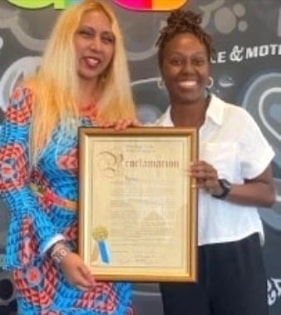 Two attendees holding proclamation at fundraiser