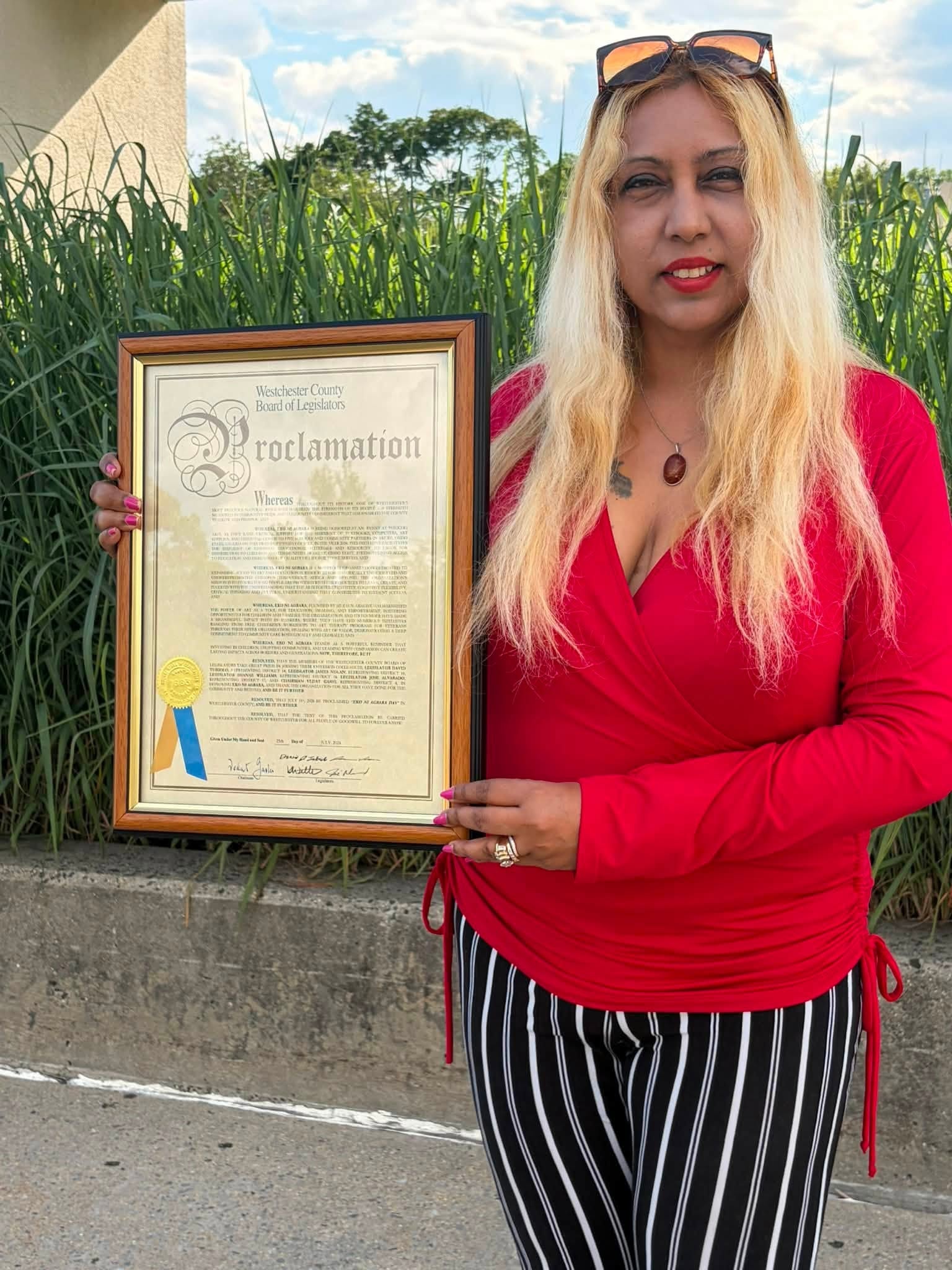 Mezaun Arnone holding the Westchester County Proclamation declaring July 31st as Eko ni Agbara Day