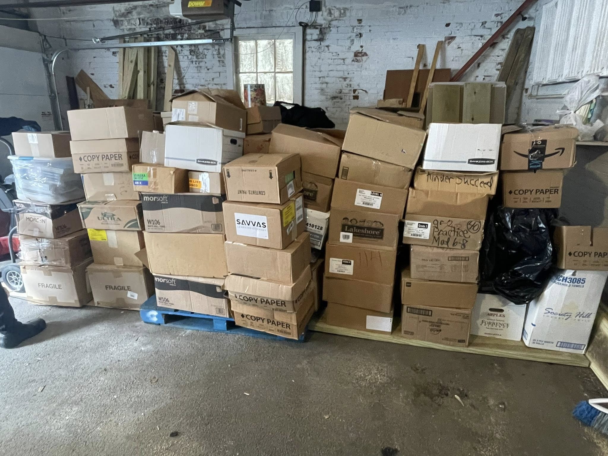 Large collection of donated textbooks and supplies in storage